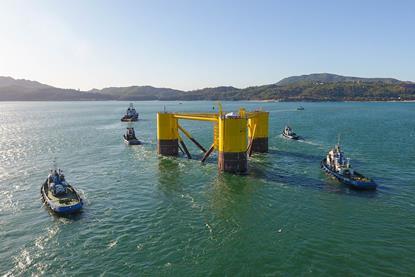 The image shows WindFloat leaving Lisnave dock after construction near Setúbal, Portugal