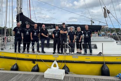 The image shows the NSSLGlobal team with the crew onboard the Ocean Youth Trust North’s yacht James Cook