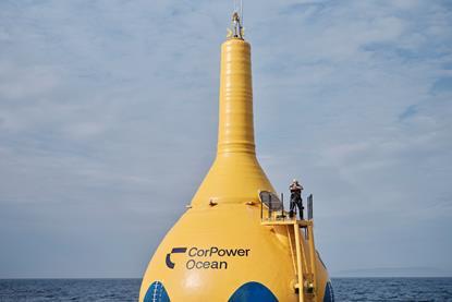 A giant CorPower Ocean yellow buoy with a man standing on top