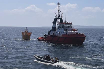 The image shows a MMS workboat on the water