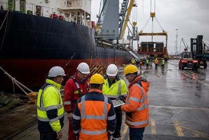 Busy harbour workers planning in the rain