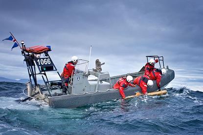 The image shows a team at sea deploying a Teledyne Gavia AUV