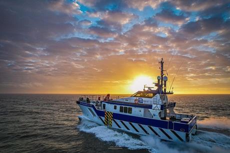 The image shows a Tidal Transit CTV on the water at sunset