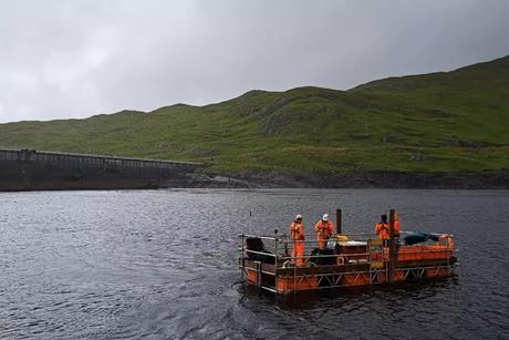 ScaffFloat floating work platform surveying onsite next to the operational dam