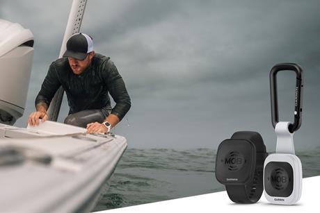 e image shows a man onboard a vessel with a cut out image of the Garmin Onboard