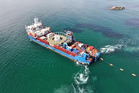 The image shows a Briggs Marine Cable Lay Vessel in action
