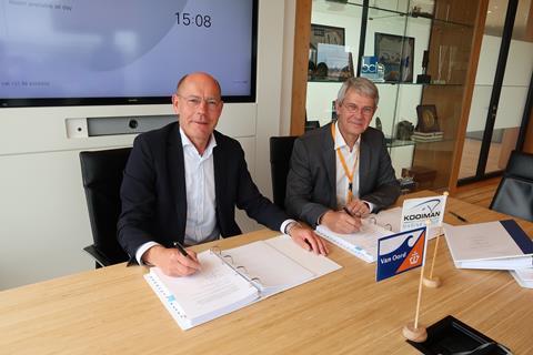 A representative from Van Oord and one from Kooiman Group signing a contract for a dredger order