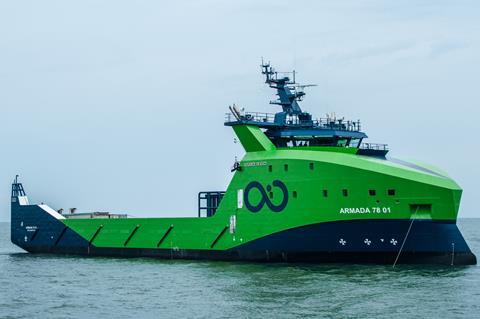 A ship painted green and blue, with the Ocean Infinity logo, out on the ocean. The ship is marked 